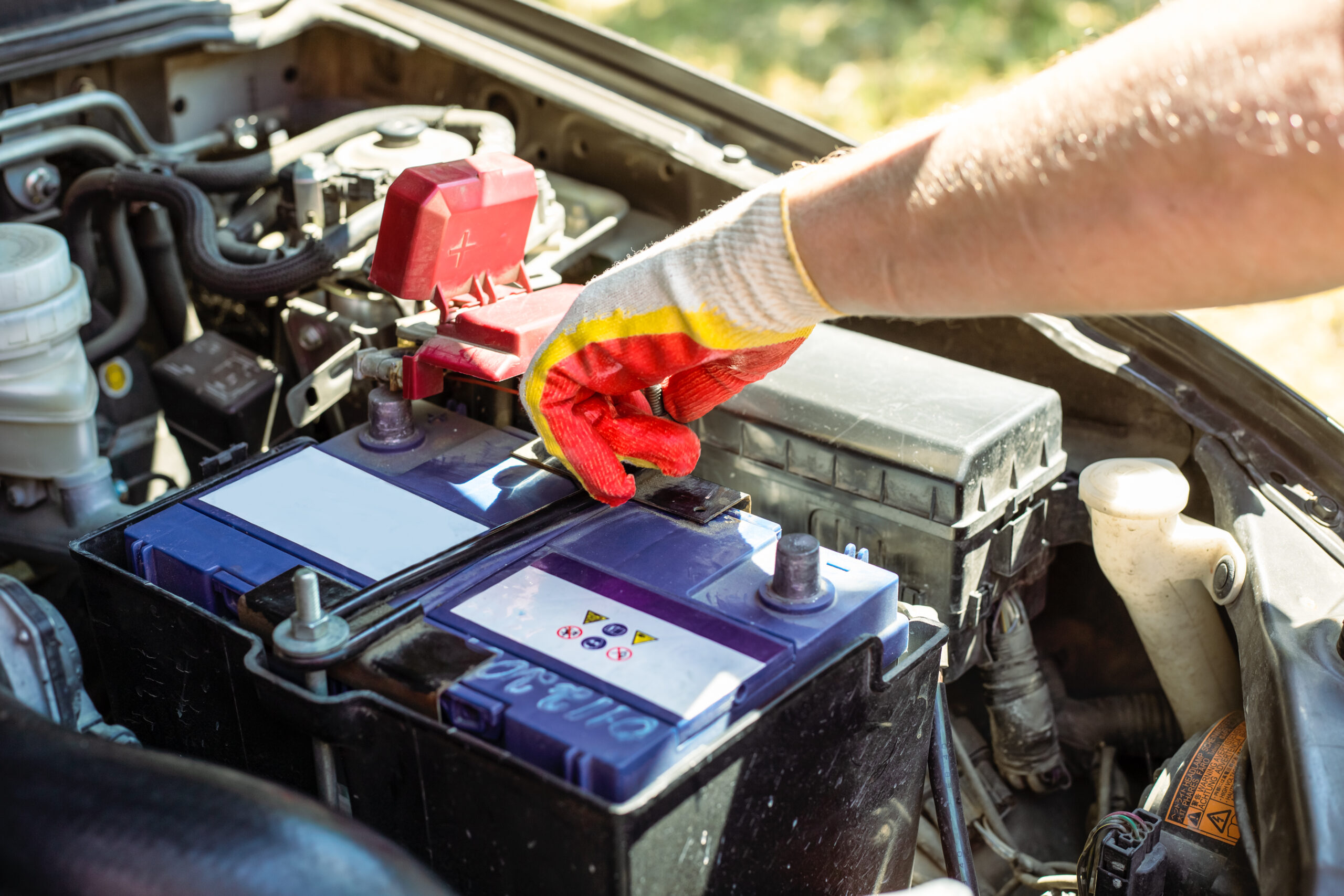 Car Battery Replacement. The Car Mechanic Repairs The Car, Unscr